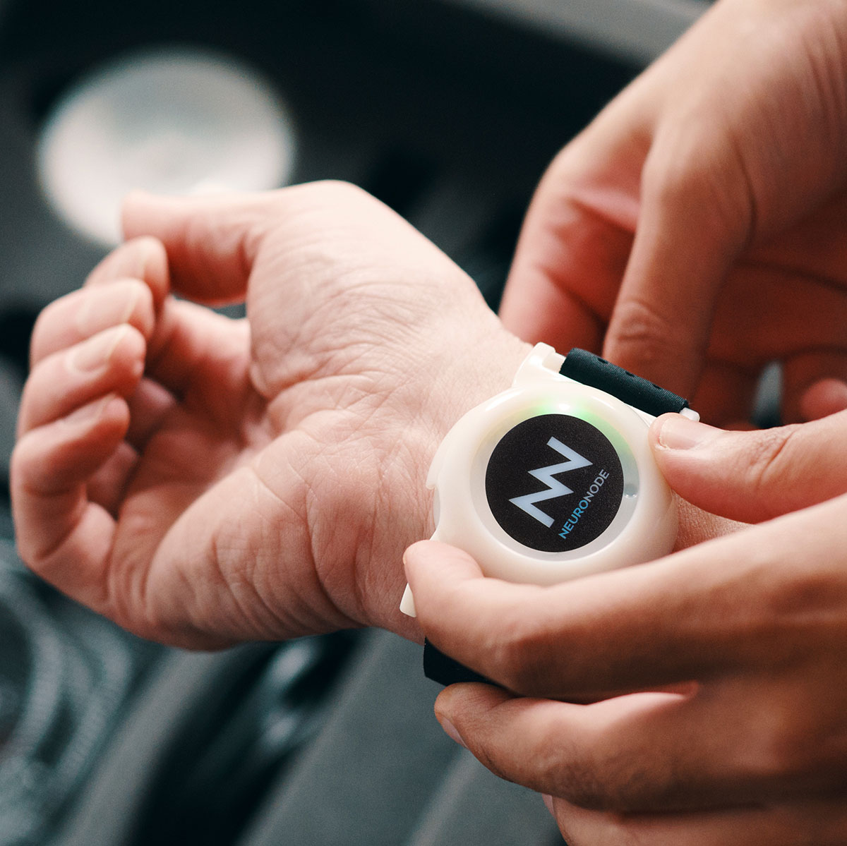 NeuroNode being attached to user's wrist by clinician photo